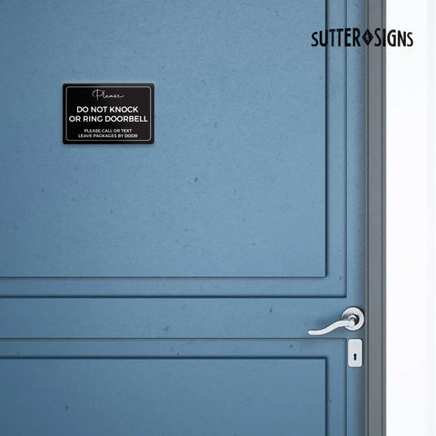 Do Not Knock Door Sign 4 By 6 Inch Durable ABS Plastic for front door, black with white text, adhesive backing shown on blue door.