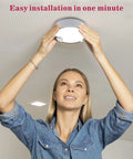 Person installing Battery Operated Motion Sensor Ceiling Light Wireless LED 7.4 Inch With All Day And Night Modes 300LM White Light
