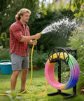 Man using Heavy Duty Freestanding Garden Hose Reel Stand With Ground Spikes Detachable Metal Rack Holds 160 Ft Hose Weatherproof Black