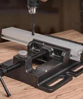 Beefy 4 Inch Heavy Duty Drill Press Vise With Quick Release Clamp Low Profile Benchtop Vise For Workbench Drills 4.3 Inch Jaw Opening And 4 Inch Jaw Width Includes 4 Bolts, shown clamping a metal workpiece