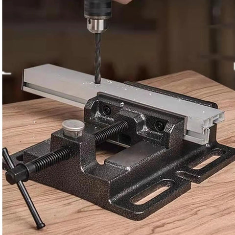 Beefy 4 Inch Heavy Duty Drill Press Vise With Quick Release Clamp Low Profile Benchtop Vise For Workbench Drills 4.3 Inch Jaw Opening And 4 Inch Jaw Width Includes 4 Bolts, shown clamping a metal workpiece