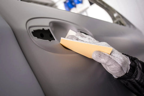 Person using Soft Hand Sanding Sheets 4.5 By 5 Inch Grit 240 On Perforated Roll 200 Sheets A Weight Latex Backing for sanding car door