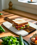 Front view: Marble and wood cutting board with handle, 13.75 x 7.25 in, charcuterie tray