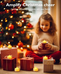 Child holding 24 Pack Battery Operated Tea Lights With Realistic Flicker And Cozy Warm Glow Flameless Votive Candles by Christmas tree