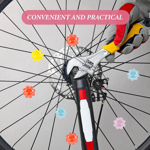 Hand installing 30 Pcs Flower Shaped Bicycle Spoke Beads Set on wheel spokes, showing colorful plastic clip decorations.