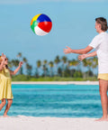 Man and child playing with inflatable beach ball by the ocean, part of Inflatable Beach Balls And Neon Sunglasses Set For Pool Party Favors 48 Pack Includes 24 Beach Balls And 24 Sunglasses Adults Summer Water Fun Toys Beach Park Backyard Party Supplies