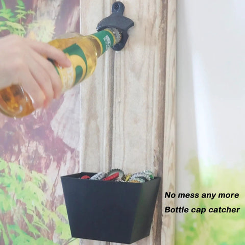 Hefty Black Cast Iron Wall Mounted Beer Bottle Opener With Spacious Cap Catcher Bucket Keeps Your Home Bar Or Man Cave Slick And Mess Free Includes Mounting Hardware in use with beer bottle.