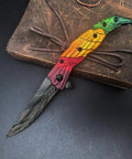 Colorful Eagle Head Embossed Folding Pocket Knife With Damascus Pattern Blade EDC on leather background