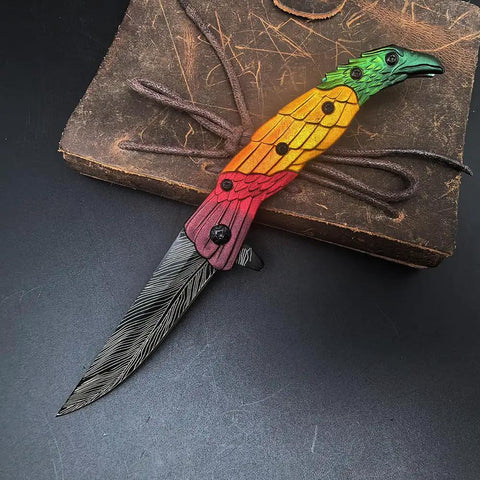 Colorful Eagle Head Embossed Folding Pocket Knife With Damascus Pattern Blade EDC on leather background
