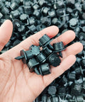 Hand holding 200 Pack Adjustable Drippers For Micro Irrigation, One Quarter Inch Barbed Emitter Sprinklers For Watering System.