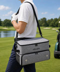 Person carrying Must Have Golf Trunk Organizer for Cars With 2 Shoe Compartments Adjustable Dividers Water Resistant Gear Bag on golf course.