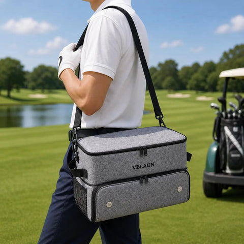 Person carrying Must Have Golf Trunk Organizer for Cars With 2 Shoe Compartments Adjustable Dividers Water Resistant Gear Bag on golf course.