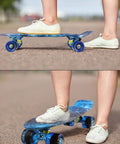 Person riding Complete Mini Cruiser Skateboard For Kids And Beginners 22 Inch Starry Sky Retro Deck with smooth wheels on pavement.
