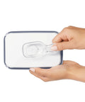 Hands holding a clear coffee scoop attached under a POP storage container lid, 2 tbsp 30 mL capacity, durable kitchen accessory.