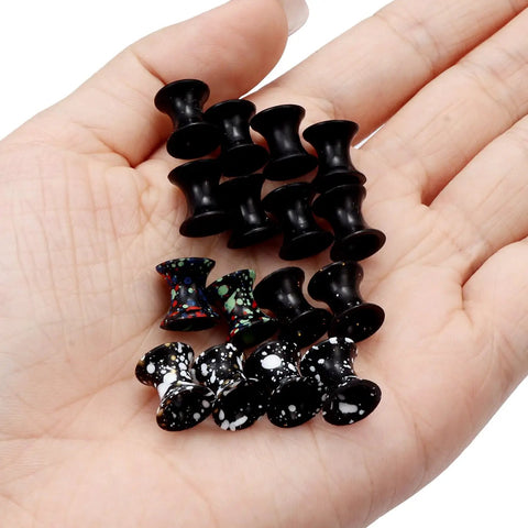 Hand holding 10 Gauge Silicone Ear Gauges Set Ultra Thin Tunnels Plugs For Ear Piercing 6 Pairs In 2.5mm Non Toxic and Non Allergenic