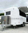 Premium Fully Equipped Food Trailer With Complete Mobile Kitchen Setup Designed For Street Vendors And Festival Catering A Ready To Roll Turnkey Business Rig Built For Serious Hustle, showing white exterior and stainless steel storage.