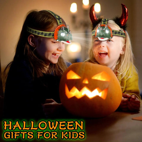 Two kids wearing Dinosaur Themed LED Headlamp For Kids And Adults Multi Mode Dino Headlamp for Halloween beside a pumpkin