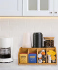 Bamboo Coffee Station Organizer With Clear Acrylic Tray Five Compartment Design For Tea Bags Condiments Pods Creamer Syrup And Cups on countertop.