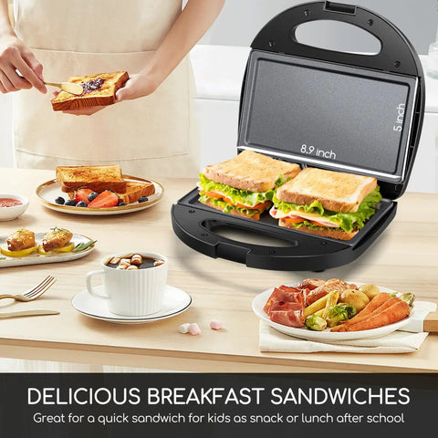 Aigostar Flat Sandwich Maker With Nonstick Deep Grill Surface, Black cooking crispy sandwiches on a table with breakfast items.