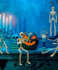 Six 16 Inch Full Body Poseable Skeletons With Movable Joints For Halloween Indoor Outdoor Spooky Decor on a mantle with candles and pumpkin