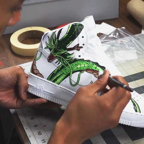 Artist painting dragon design on white shoe using Matte Acrylic Finisher 4 Fl Oz Flexible Clear Coat For Leather Shoes Bags Jackets And Accessories Dope Pro Grade Matte Sealant Varnish For Leather Craft And Restoration Restores Color, Adds Scratch Resistant, Long Lasting Protection No 620.