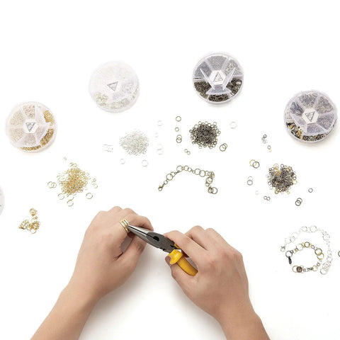 Over 1000 Open Jump Rings Kit With 40Pcs 12Mm Lobster Clasps And Jump Ring Opener in use for jewelry making on a white surface.