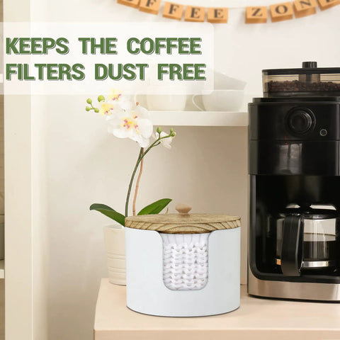 Go-To Coffee Filter Holder With Lid For Countertop Storage next to coffee machine and plant, shown with basket style filter.