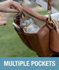 Brown Crossbody Diaper Bag Tote with multiple pockets attached to stroller, showing organizer for baby essentials.