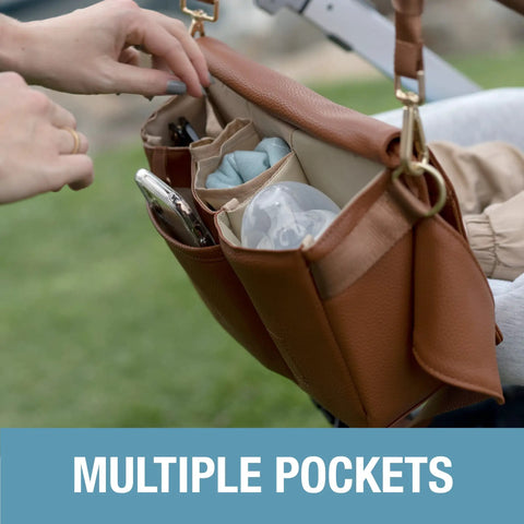 Brown Crossbody Diaper Bag Tote with multiple pockets attached to stroller, showing organizer for baby essentials.