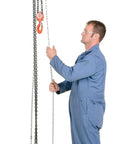 Heavy-Duty Hand Chain Hoist With Hook Mount, One-Half Ton Capacity, 15 Ft Lift, 11 In Headroom in use by worker
