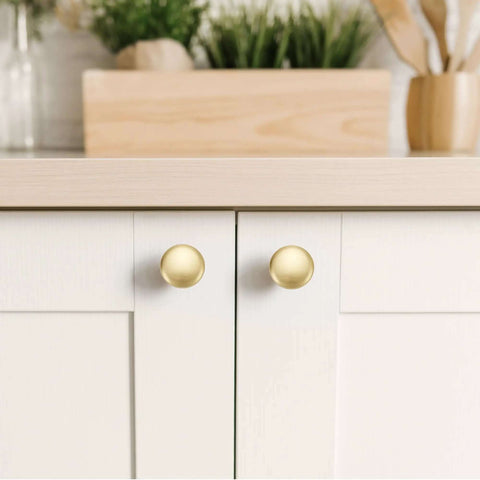 Top Shelf Solid Cabinet and Drawer Knob Sets with Kickass Brushed Gold Finish Crafted from Heavy Duty Zinc Alloy for Built Tough Kitchen and Bath Remodel Upgrades, round brushed gold knobs on white cabinet.