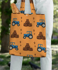 Blue Farm Tractor Aesthetic Canvas Tote Bag for Women and Girls with tractor design, held by person outdoors.