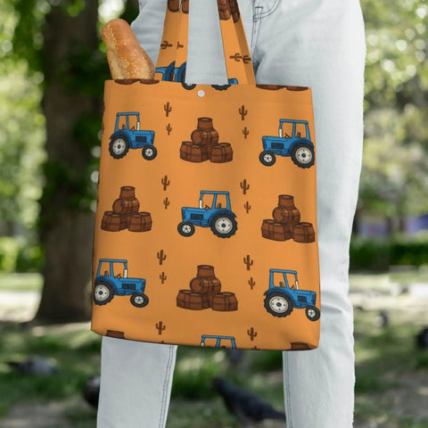 Blue Farm Tractor Aesthetic Canvas Tote Bag for Women and Girls with tractor design, held by person outdoors.