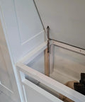 Installed 2 Pack 150N Gas Strut Hinges With No Slam Soft Close Hydraulic Support for heavy lids on a white storage trunk.