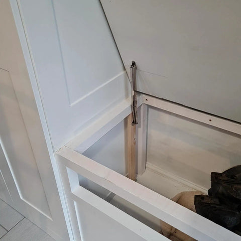 Installed 2 Pack 150N Gas Strut Hinges With No Slam Soft Close Hydraulic Support for heavy lids on a white storage trunk.