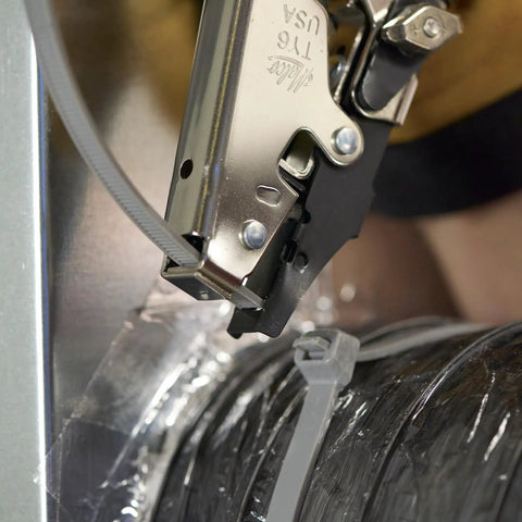 Close-up of HVAC Flex Duct Cable Tie Tensioning Tool with Auto Cut Off securing duct with nylon tie