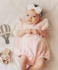 Baby with Wooden Hot Air Balloon Monthly Milestone Cards For Babies, My First Year Sign, Balloons Milestone Marker beside.