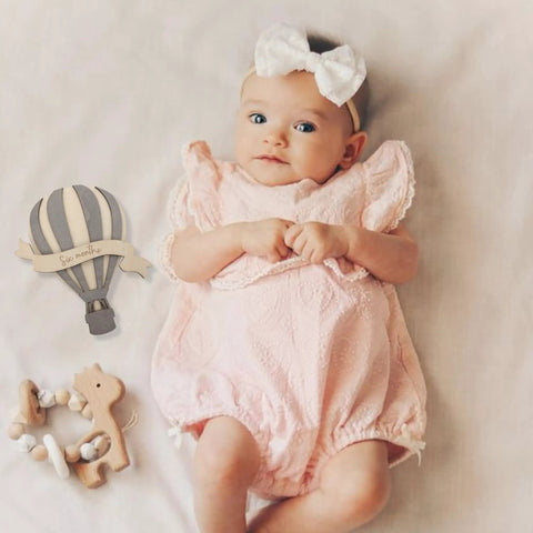 Baby with Wooden Hot Air Balloon Monthly Milestone Cards For Babies, My First Year Sign, Balloons Milestone Marker beside.