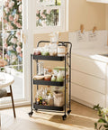 No Tools Needed Foldable Rolling Cart With Three Tiers In Black Metal Finish, Easy Unfold And Lock Setup, Heavy Duty Mobile Storage Organizer On Wheels For Office Garage Tools Kitchen And More next to a kitchen counter with items.