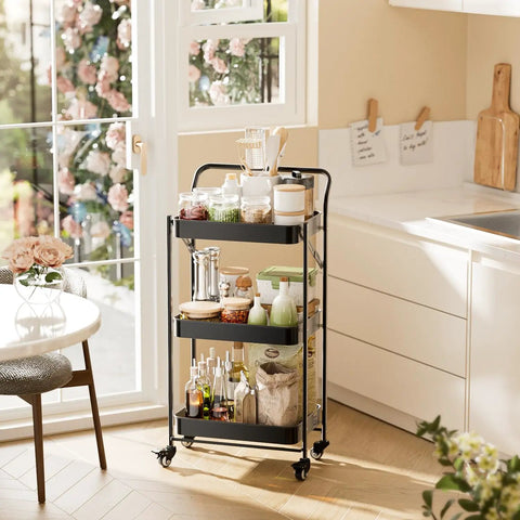 No Tools Needed Foldable Rolling Cart With Three Tiers In Black Metal Finish, Easy Unfold And Lock Setup, Heavy Duty Mobile Storage Organizer On Wheels For Office Garage Tools Kitchen And More next to a kitchen counter with items.