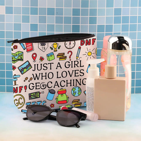 Geocaching Makeup Bag Gift For Her with colorful geocaching icons and text, alongside sunglasses and cosmetic bottles on tiled background.