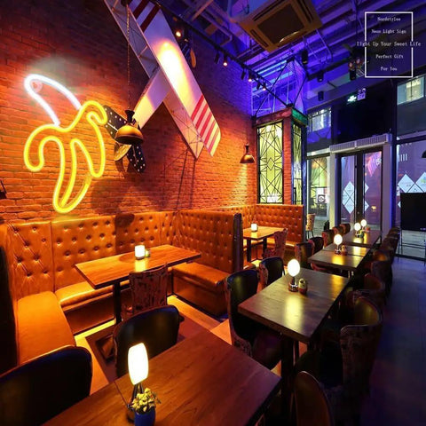 Restaurant interior with Banana Neon Sign LED Light 11.4 x 7.9 Inches USB or Battery Powered Wall Decor Night Lamp.