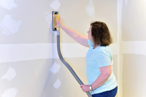 Person using Dust Free Drywall Vacuum Hand Sander With Six Foot Hose For Any Wet Dry Vacuum Easy Clamp Sanding Screen Replacement
