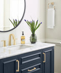 Bathroom with navy cabinets featuring Mulholland Champagne Bronze Cabinet Pull 5-1/16 Inch Center to Center Drawer Handle.