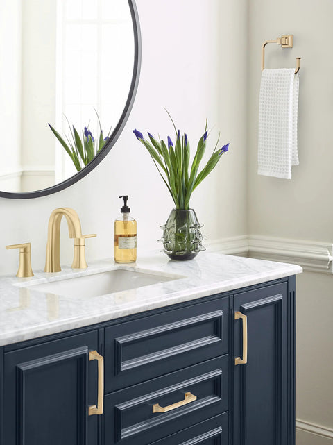 Bathroom with navy cabinets featuring Mulholland Champagne Bronze Cabinet Pull 5-1/16 Inch Center to Center Drawer Handle.