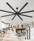 108-inch HVLS black ceiling fan with 8 blades and remote in a modern showroom.