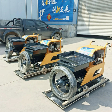 Three Heavy Duty Multifunctional Construction Spraying Machines for Cement Sand Mortar on wooden pallets outdoors.