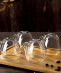 Double Wall Insulated Espresso Cups Set Of Two Borosilicate Glass Demitasse Mugs With Handle on a wooden tray.
