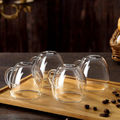 Double Wall Insulated Espresso Cups Set Of Two Borosilicate Glass Demitasse Mugs With Handle on a wooden tray.