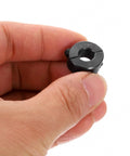Hand holding a Double Split Shaft Collar Kit For 5/16 Inch Shafts With Two-Piece Clamping Collar 11/16 Inch Outer Diameter in black oxide steel.